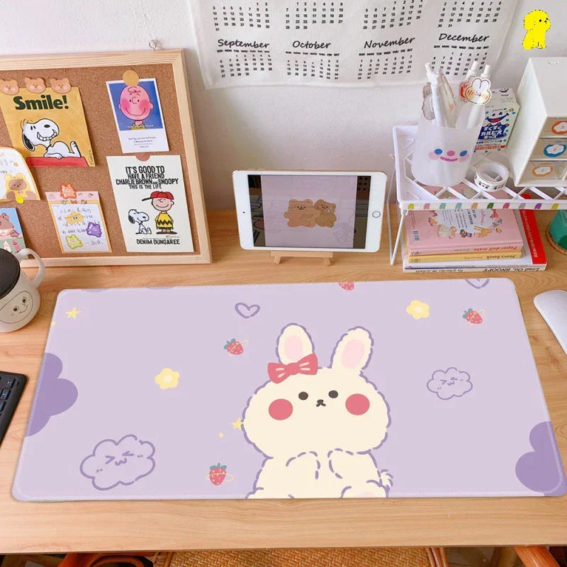 Cute pastel bunny desk mat with bow on organized workspace, kawaii decor and stationery