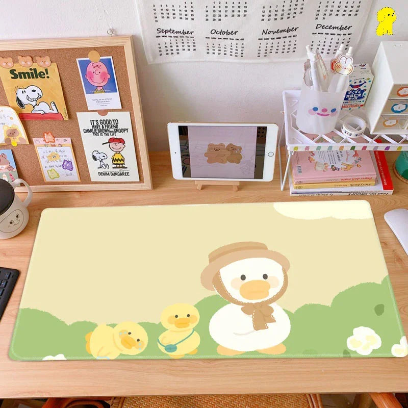 Cute duck-themed desk mat on a tidy workspace with cartoon decor and tablet display