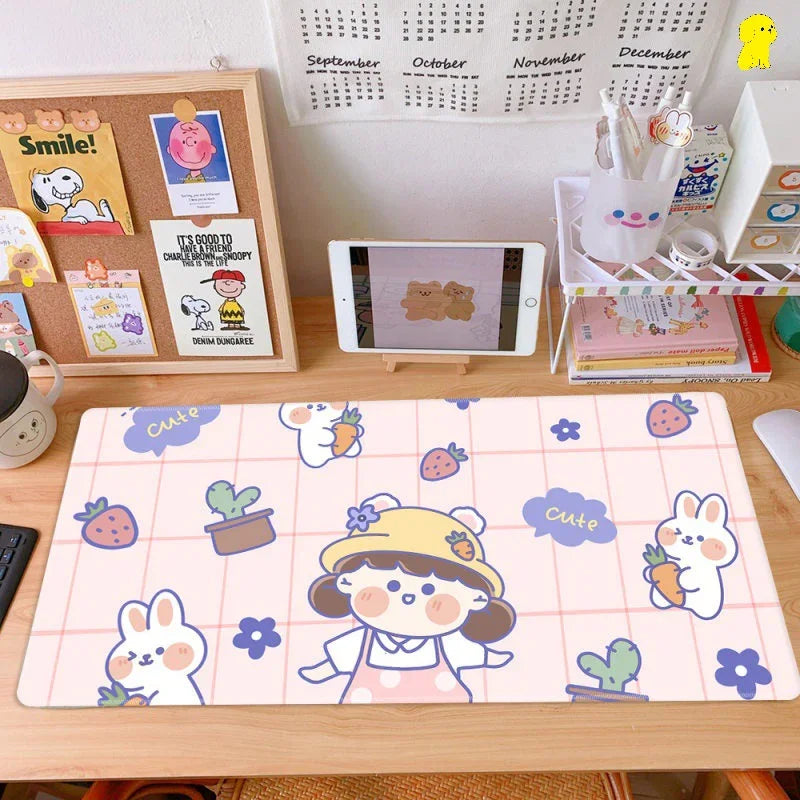 Cute pastel desk mat with cartoon girl, bunnies, strawberries, and cactus on organized workspace