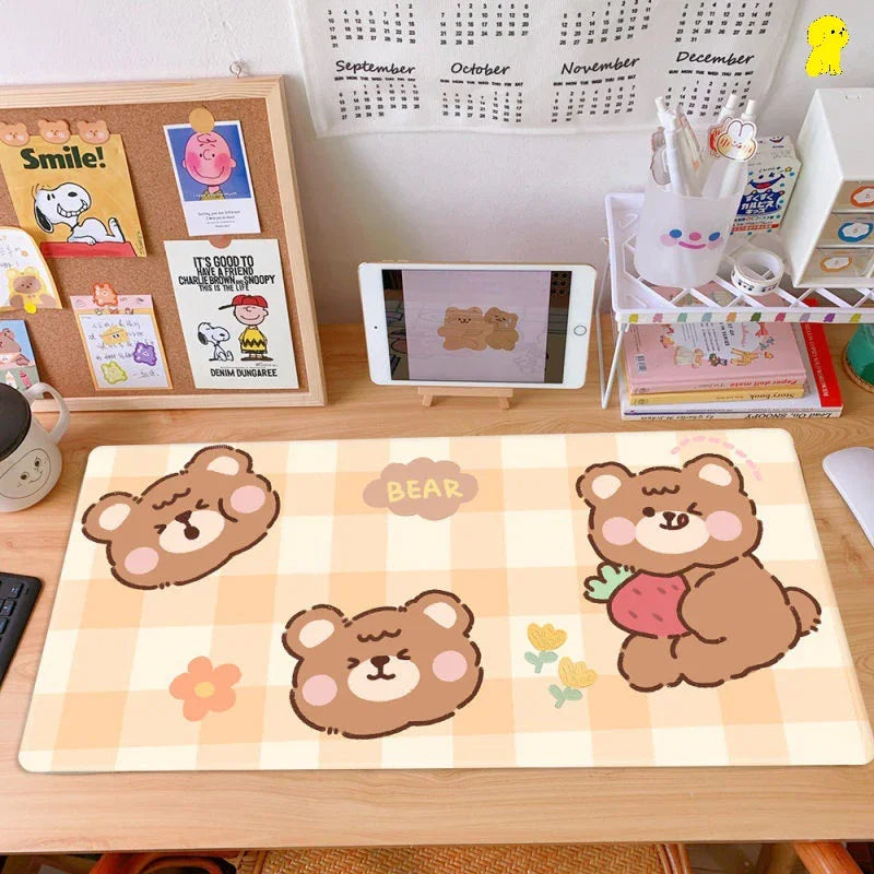 Cute bear desk mat with pastel checkered pattern on a tidy workspace with tablet and stationery.