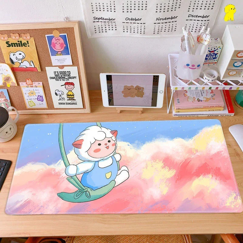 Cute sheep cartoon desk mat on wooden workspace with pastel clouds and organized accessories