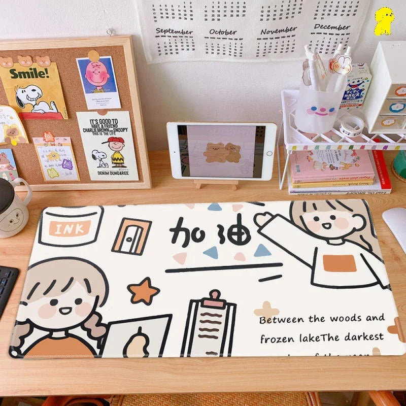 Cute cartoon desk mat on a tidy workspace with tablet, books, and stationery, ideal for modern home office organization.
