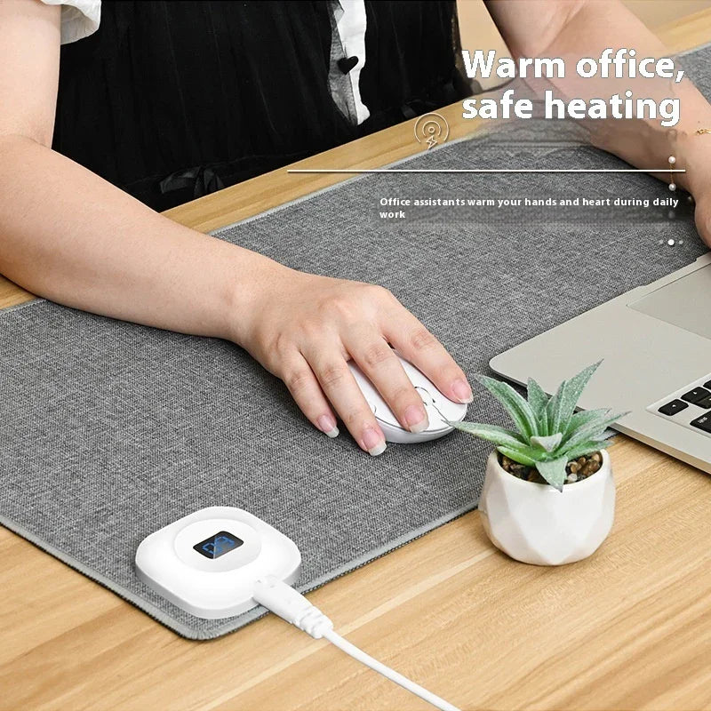 Heated desk pad for office with digital control, gray mat under laptop and mouse, succulent decor