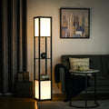 Modern floor lamp with shelves illuminating a cozy living room with a couch and cityscape art